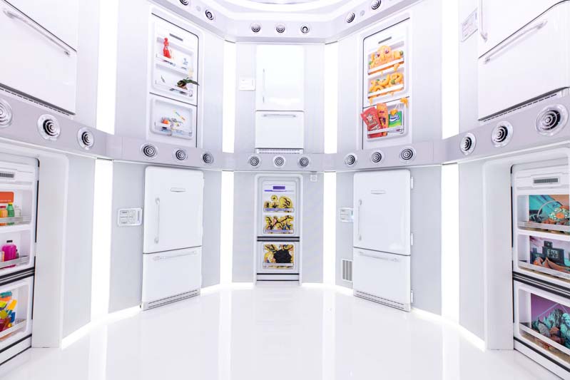 white circular room with so many fridge doors to choose from inside Meow Wolf