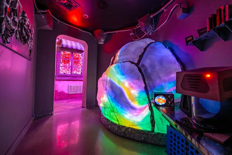 multi-colored globe shape on the right and a doorway leading to an unknown space to the left inside Radio Tave
