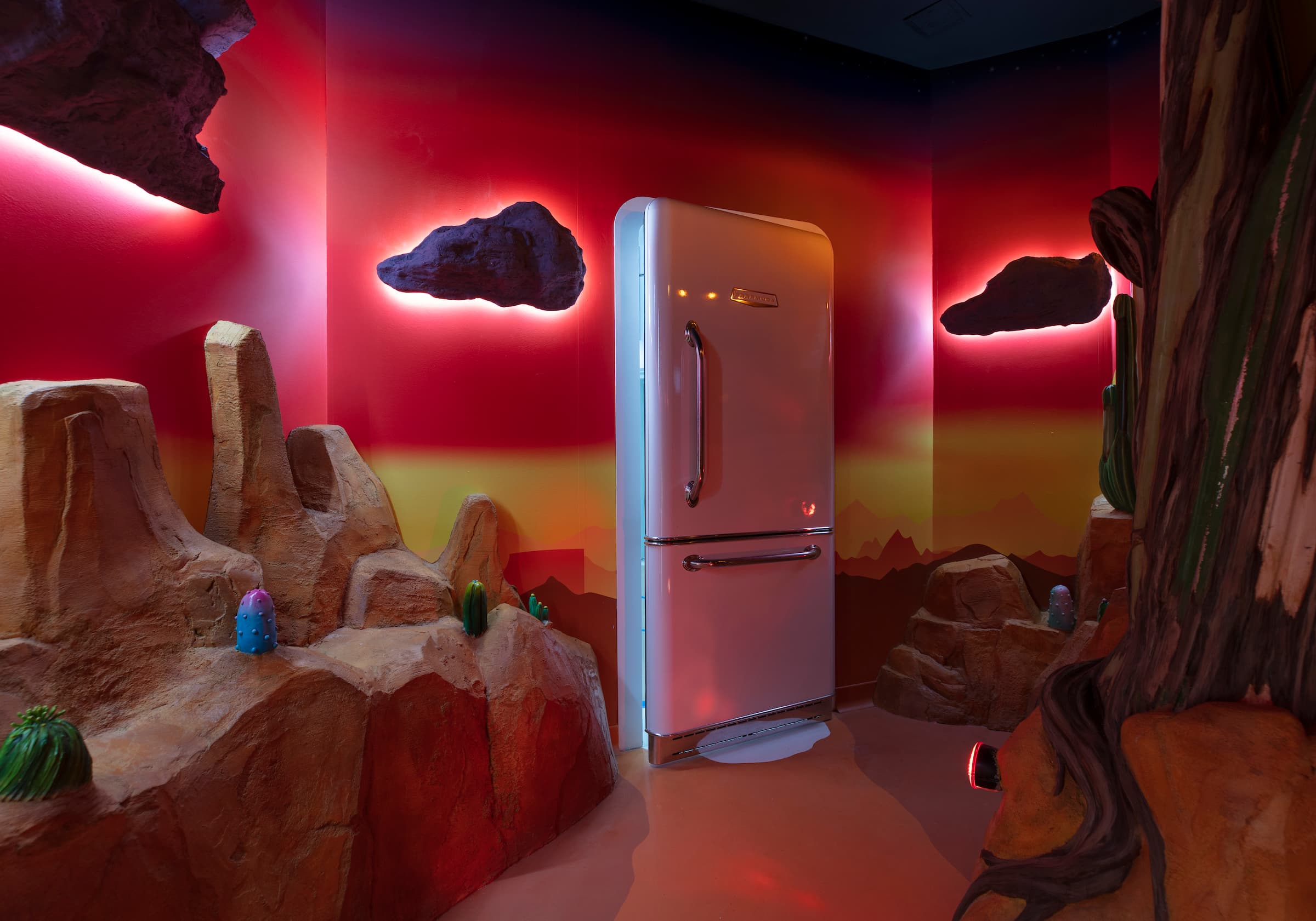 a fridge glowing in a pink-hued room at Meow Wolf in Grapevine, TX