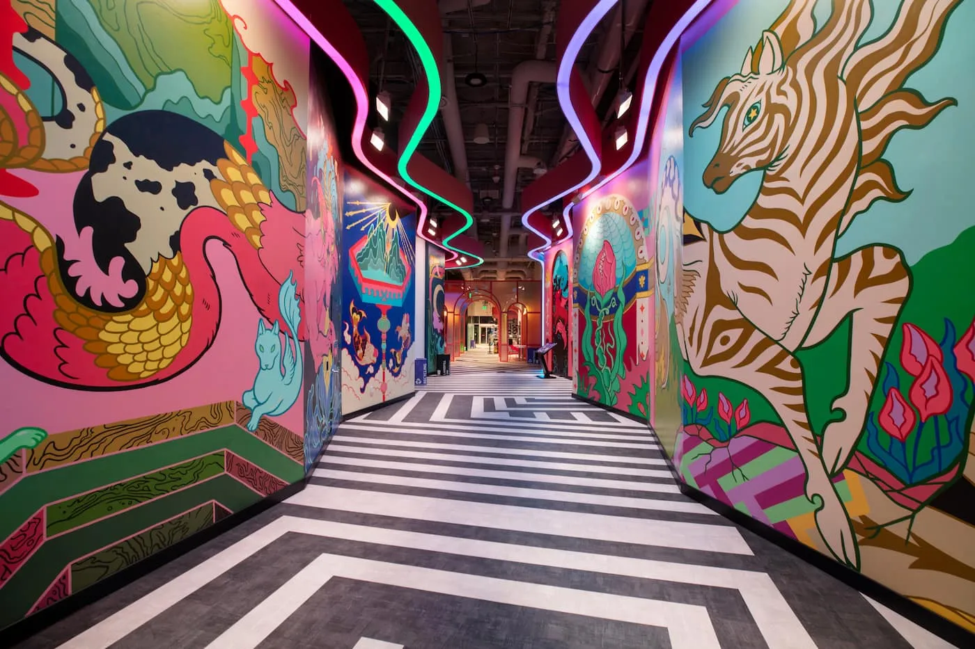 bright murals with animals on the walls and a black and white floor