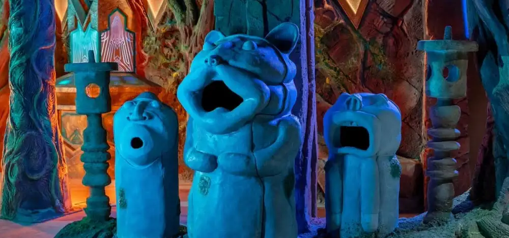 A group of otherworldly creatures singing in a forest space at Meow Wolf Houston
