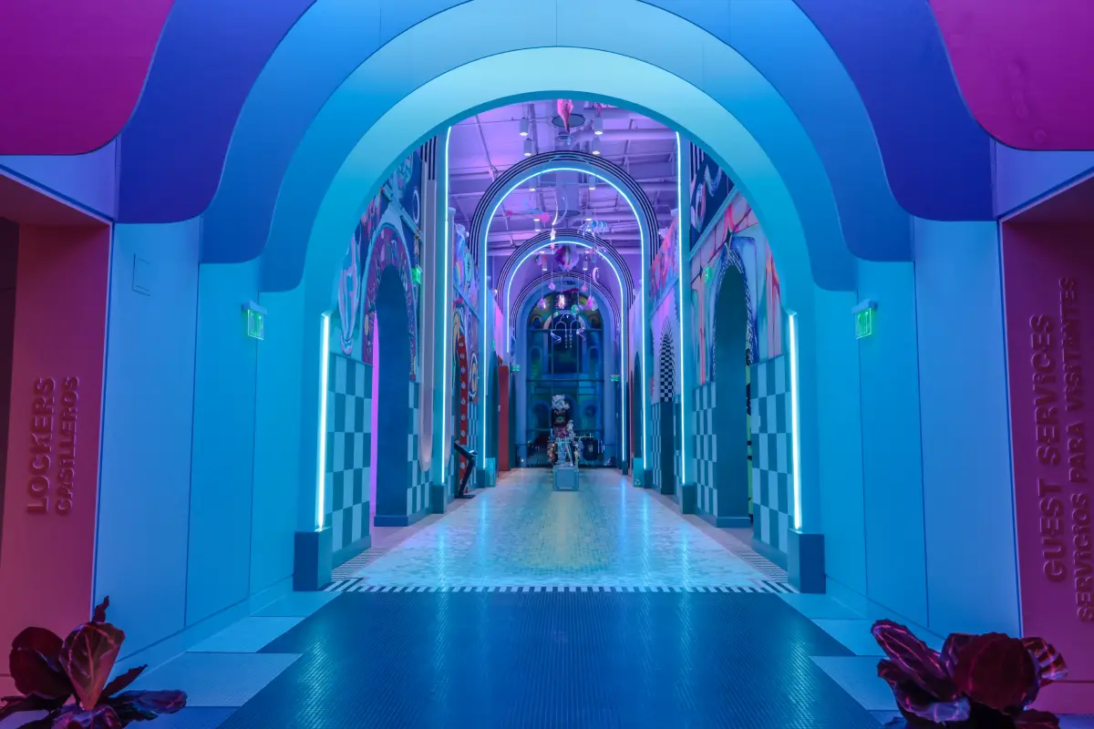 A blue hallway with rounded archways.