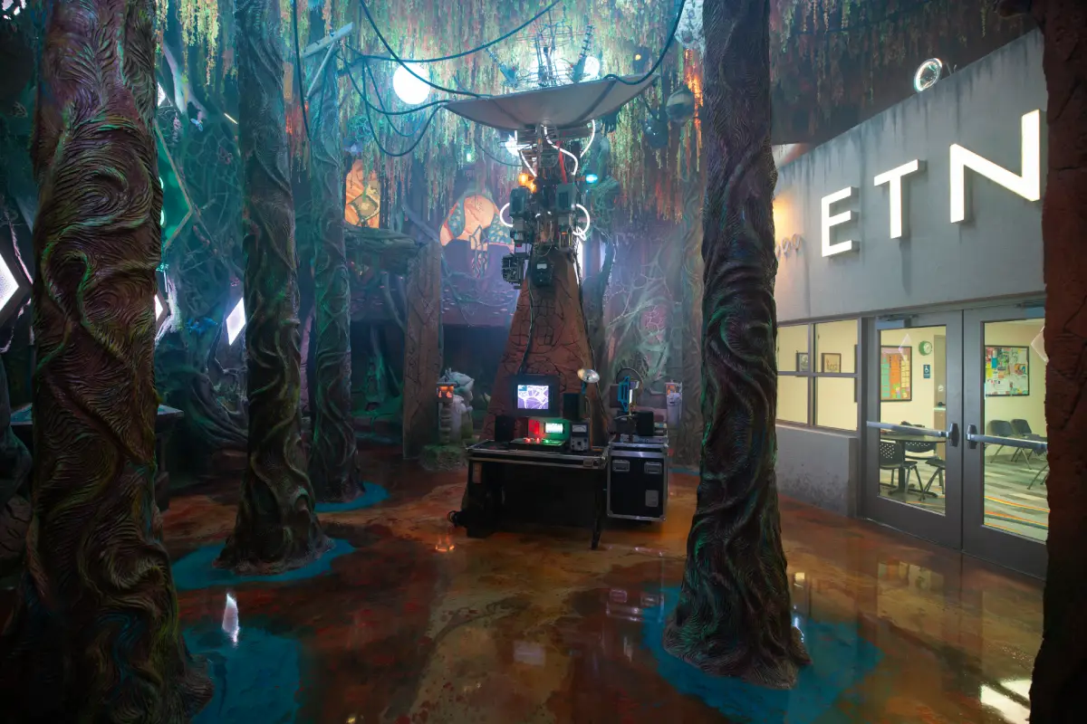 A forest with a satellite outside of a radio station.