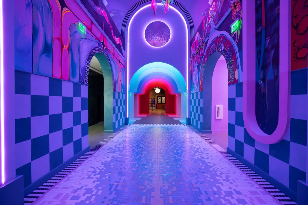 A pink and purple psychedelic hallway with rounded archways.