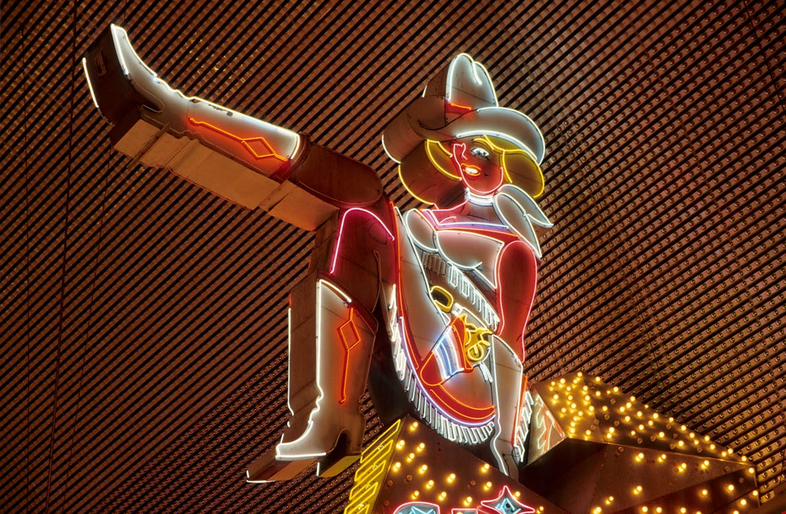 Neon cowgirl sign in Downtown Las Vegas on Fremont Street.