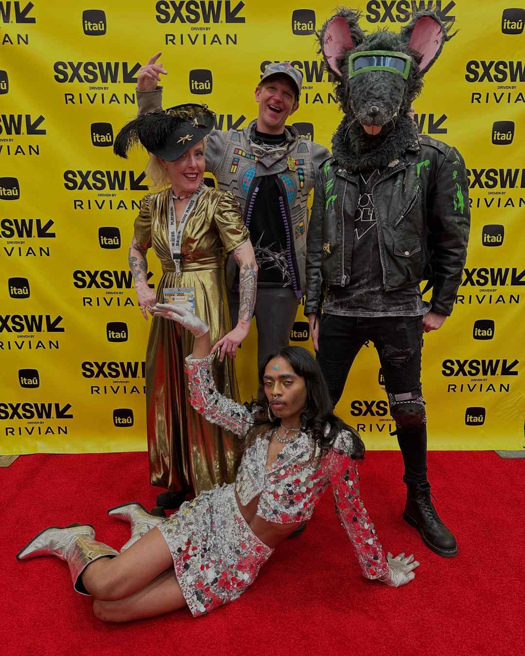 Wildly dressed Meow Wolf employees and influencers pose on the SXSW red carpet