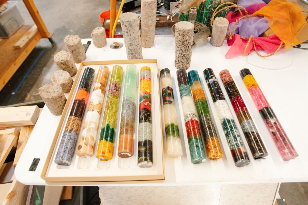 A set of multicolored vials on a white table.