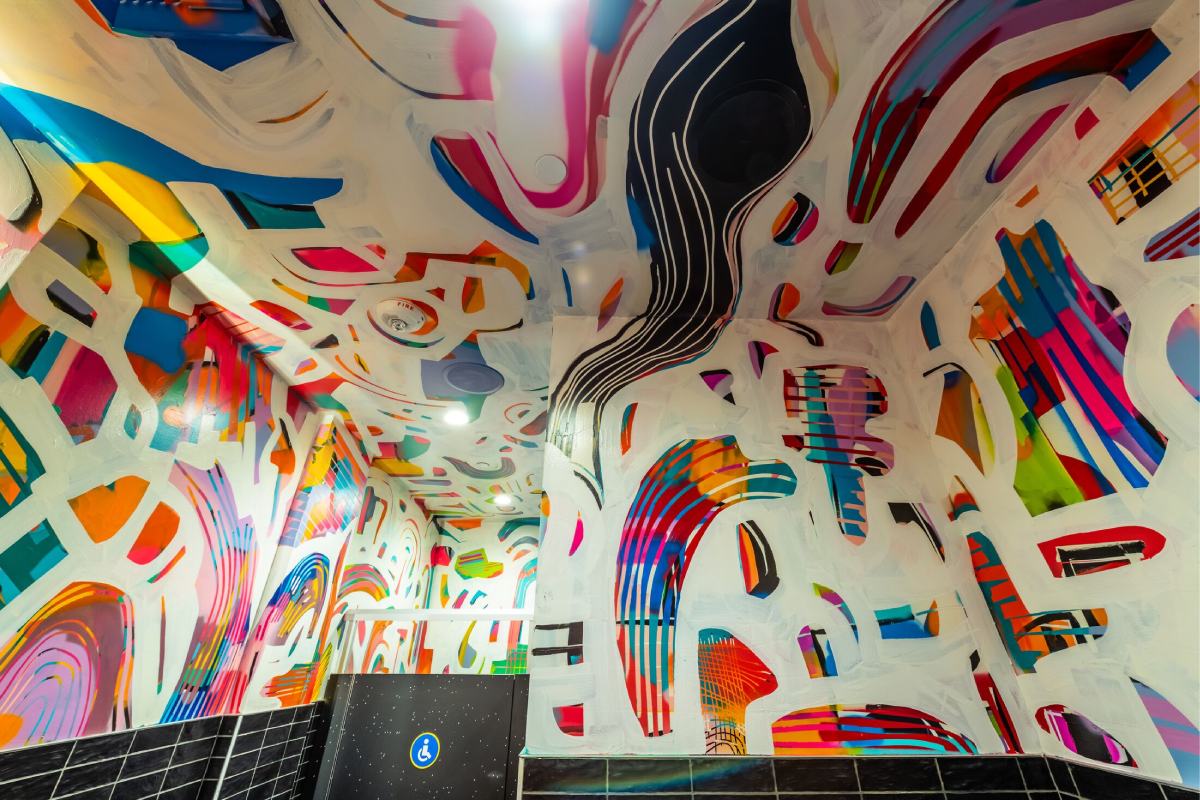 A colorful patterned wall with various shapes and designs.