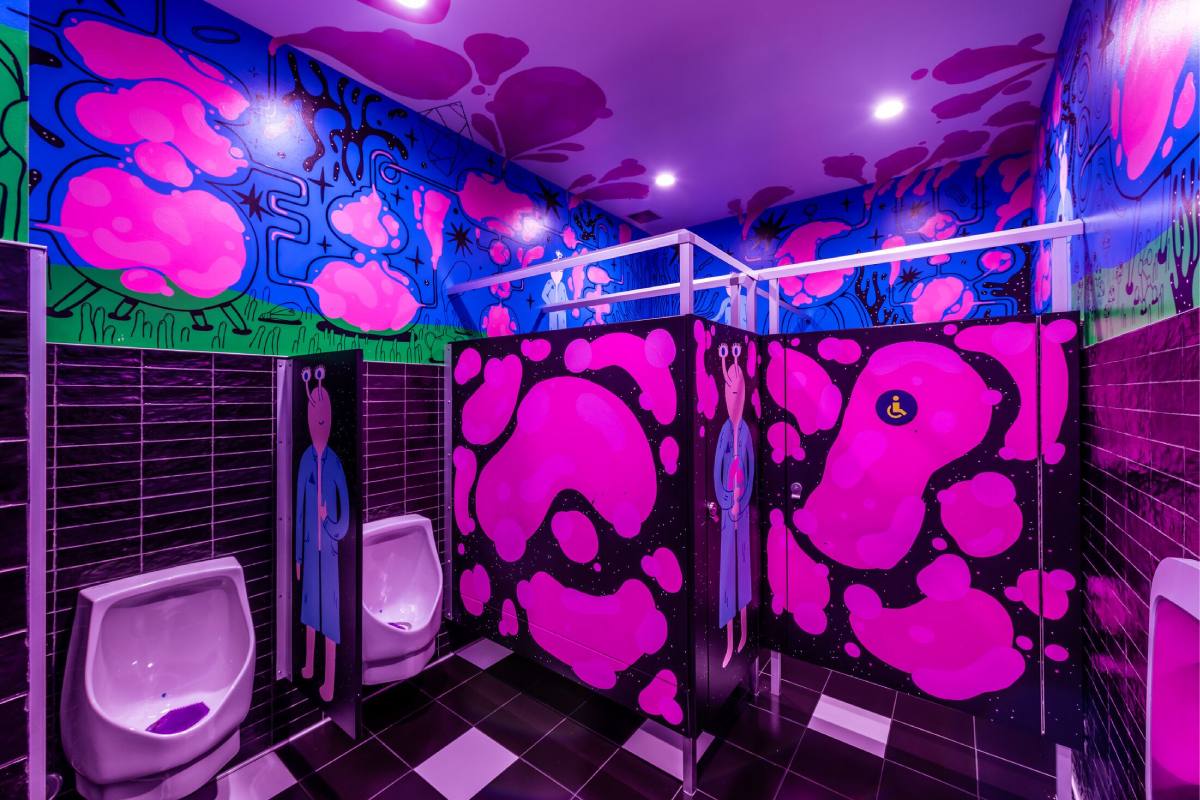 A bathroom with pink blobs painted on the doors and walls.
