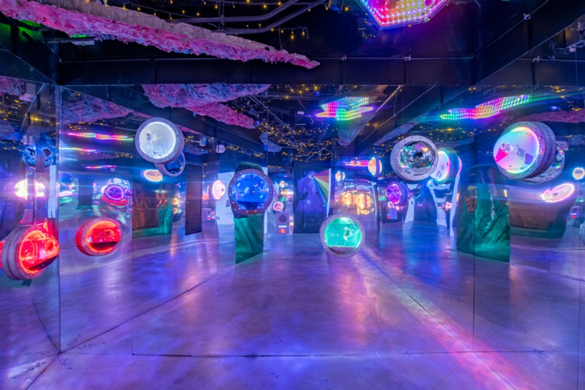 A metal room with colorful orbs with little creatures inside.