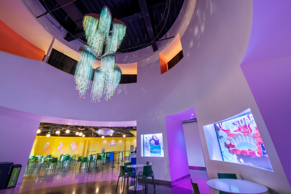 The front lobby of Convergence Station with white walls and the cafe in the distance.