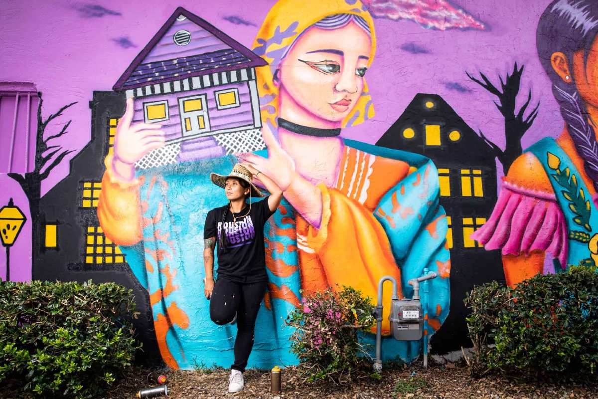Royal Sumikat poses with their mural.