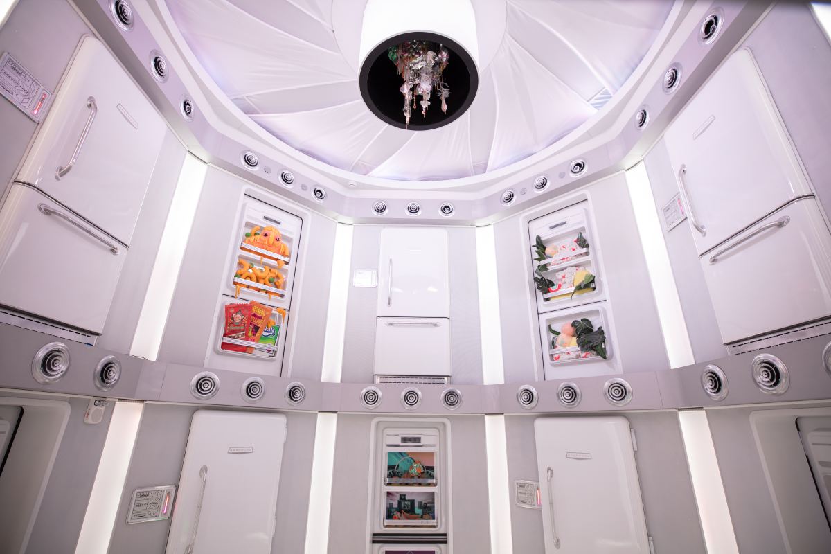 A white room with different refridgerator doors around the room.