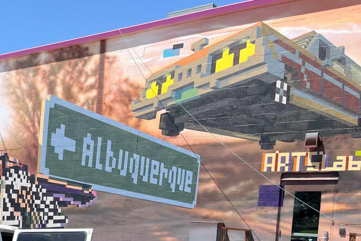 A building with a mural on it that has an Albuquerque street sign, car, and the word “Arts Lab” in voxel style.