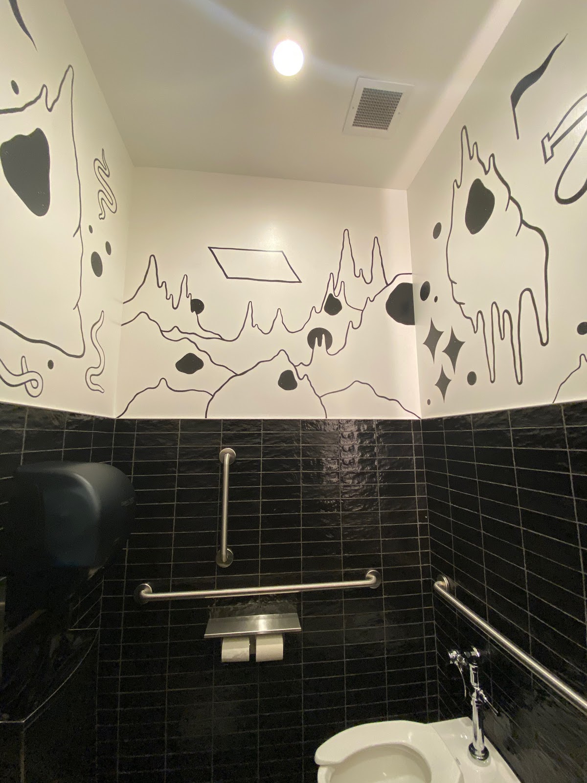 Restroom mural based on the Mojave Desert environment, uses black and white to match the bathroom fixtures and keep things uniform and immersive. 