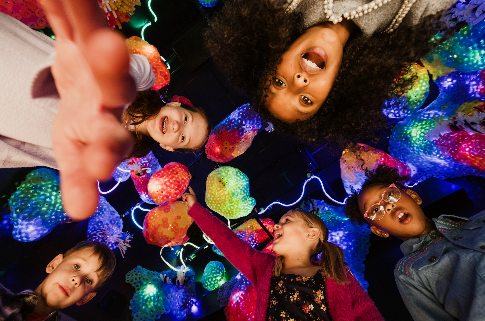 group of children with a fun colorful background looking at the camera