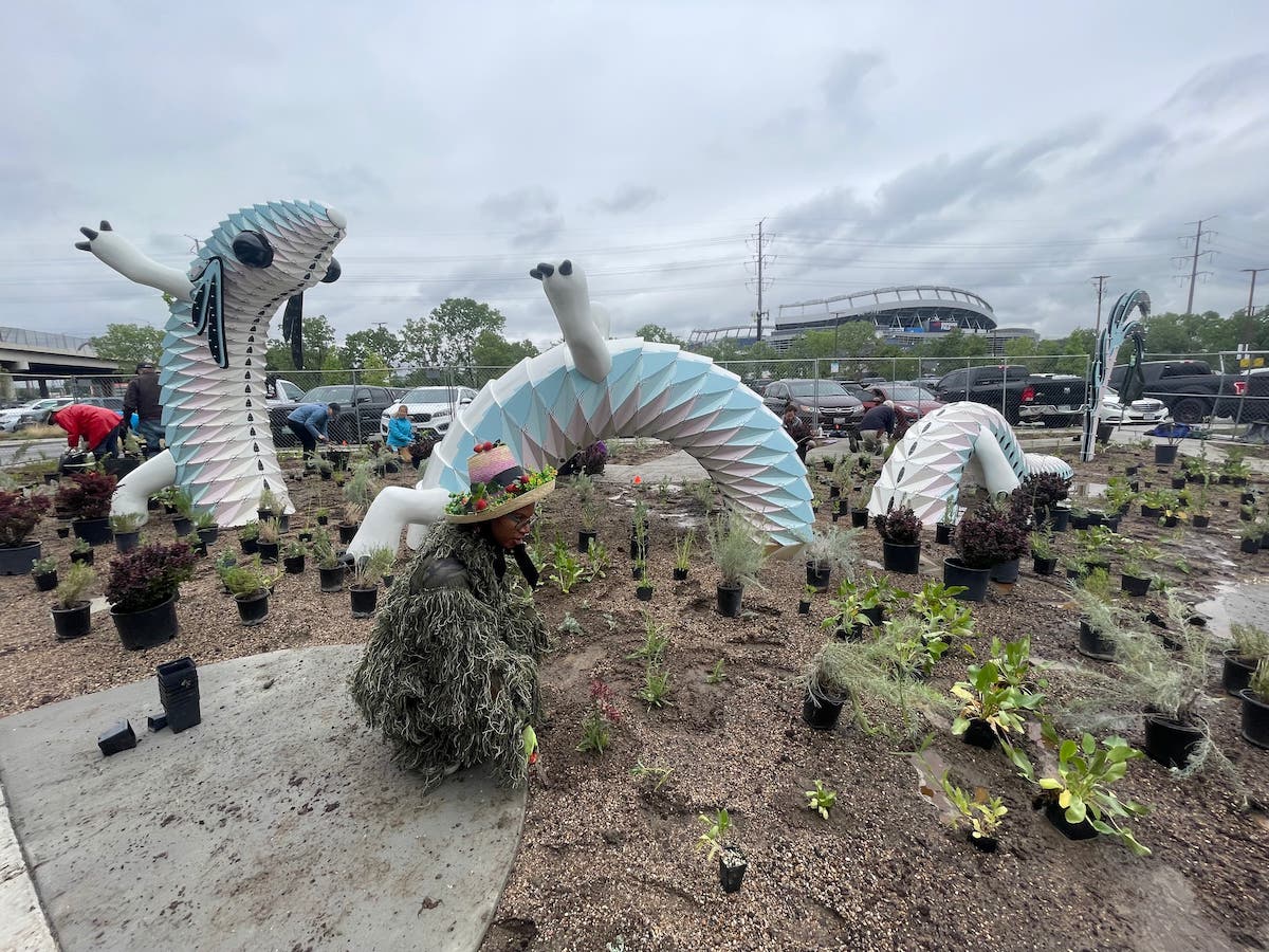 People planting in garden outside of Convergence Station next to the Plethodon
