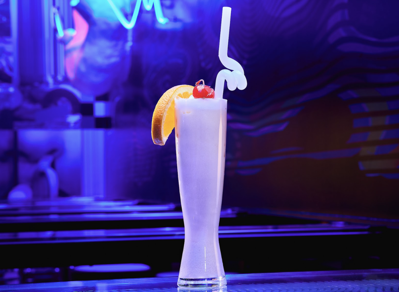 pink drink with orange slice and swirly straw