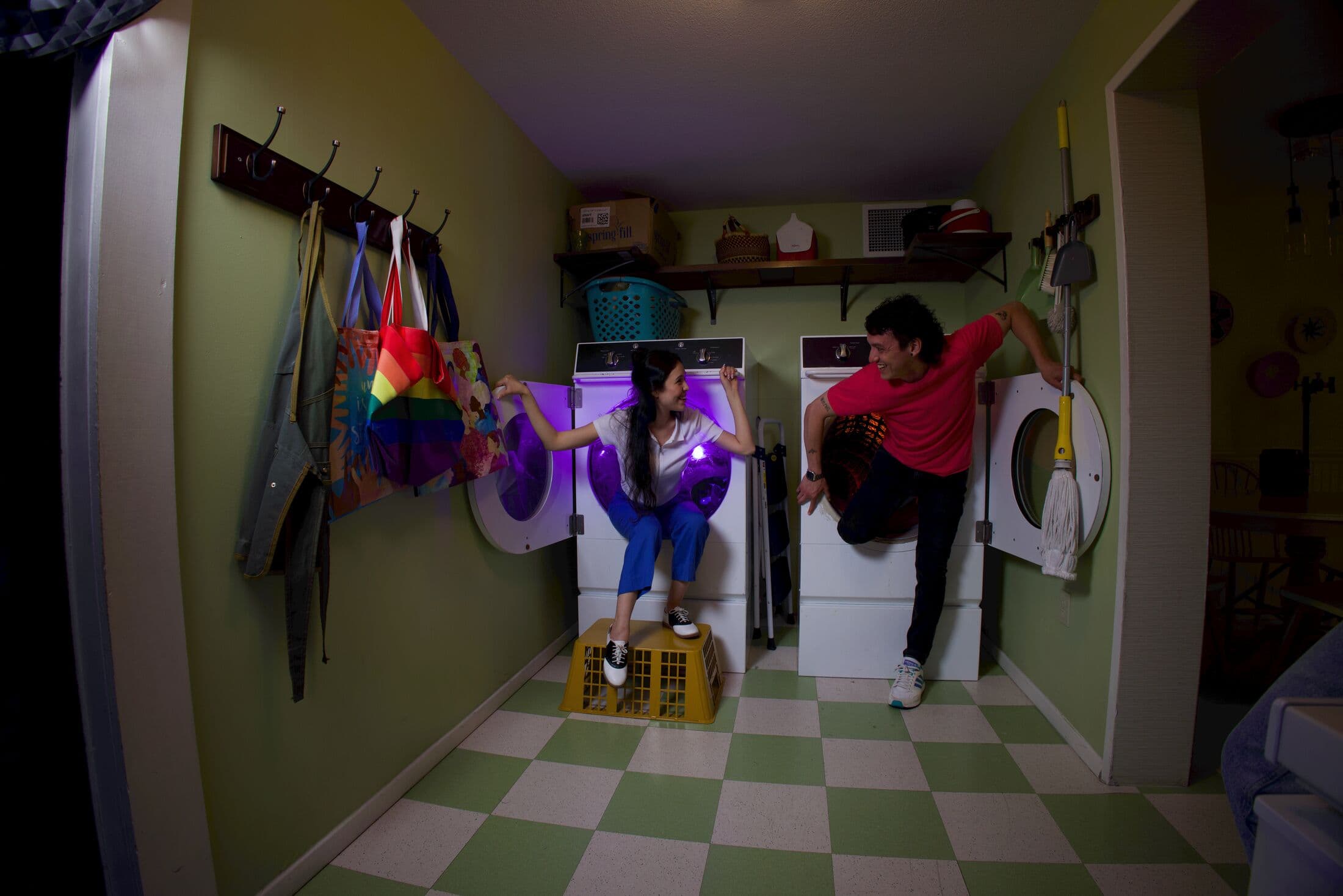 two people climbing out of dryers at Meow Wolf