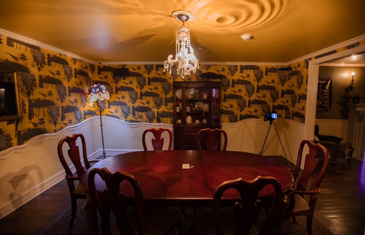 an unusal dining room with a rippling portal on the ceiling and melting walls