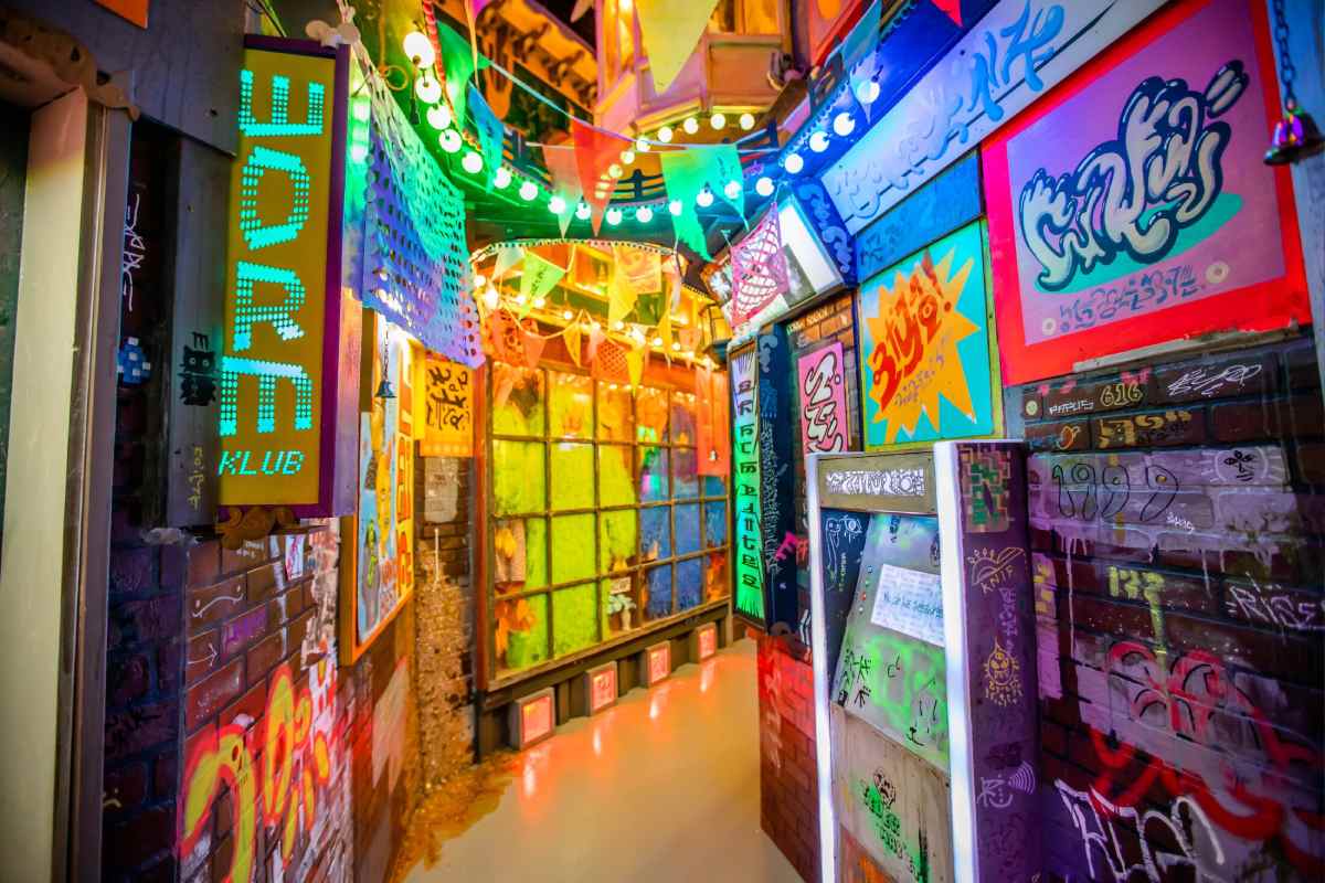 A neon alleyway with unknown script on the signs.