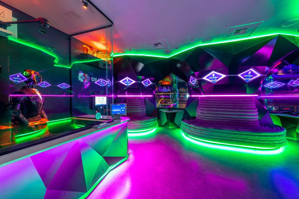 A neon reception area with green lights and a robot receptionist.