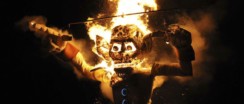 burning Zozobra against a dark night sky