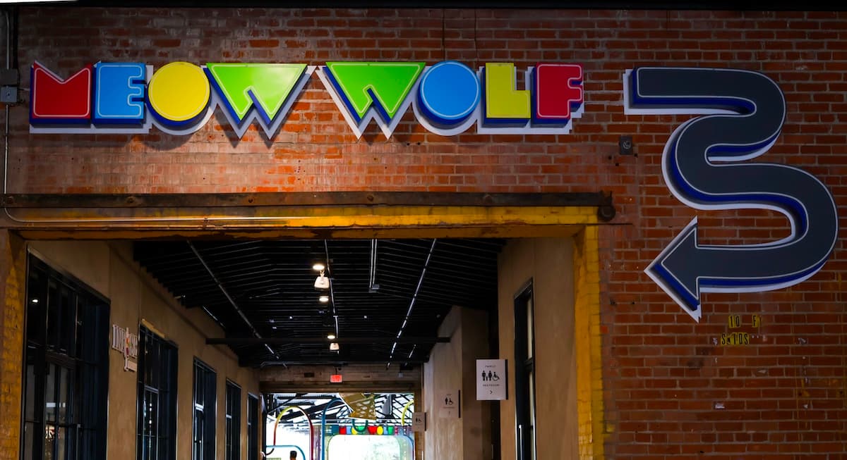 Meow Wolf logo on a brick building